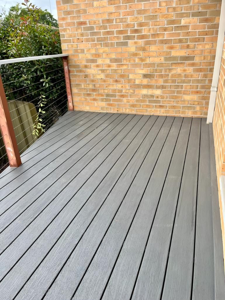 Gray Deck With a Brick Wall in the Background — TM Built Construction In Singleton, NSW