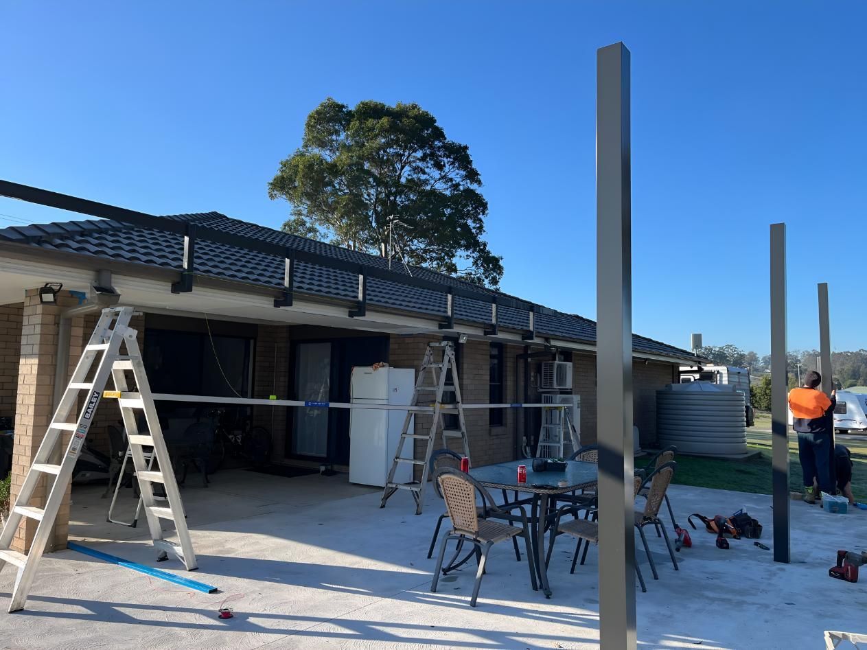 Ladder is Sitting in Front of a House — TM Built Construction In Singleton, NSW
