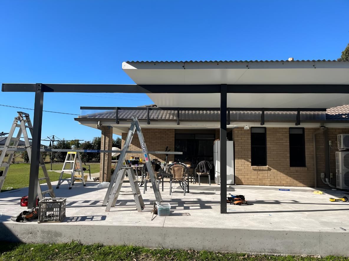 Brick House With a Patio and a Ladder — TM Built Construction In Maitland, NSW