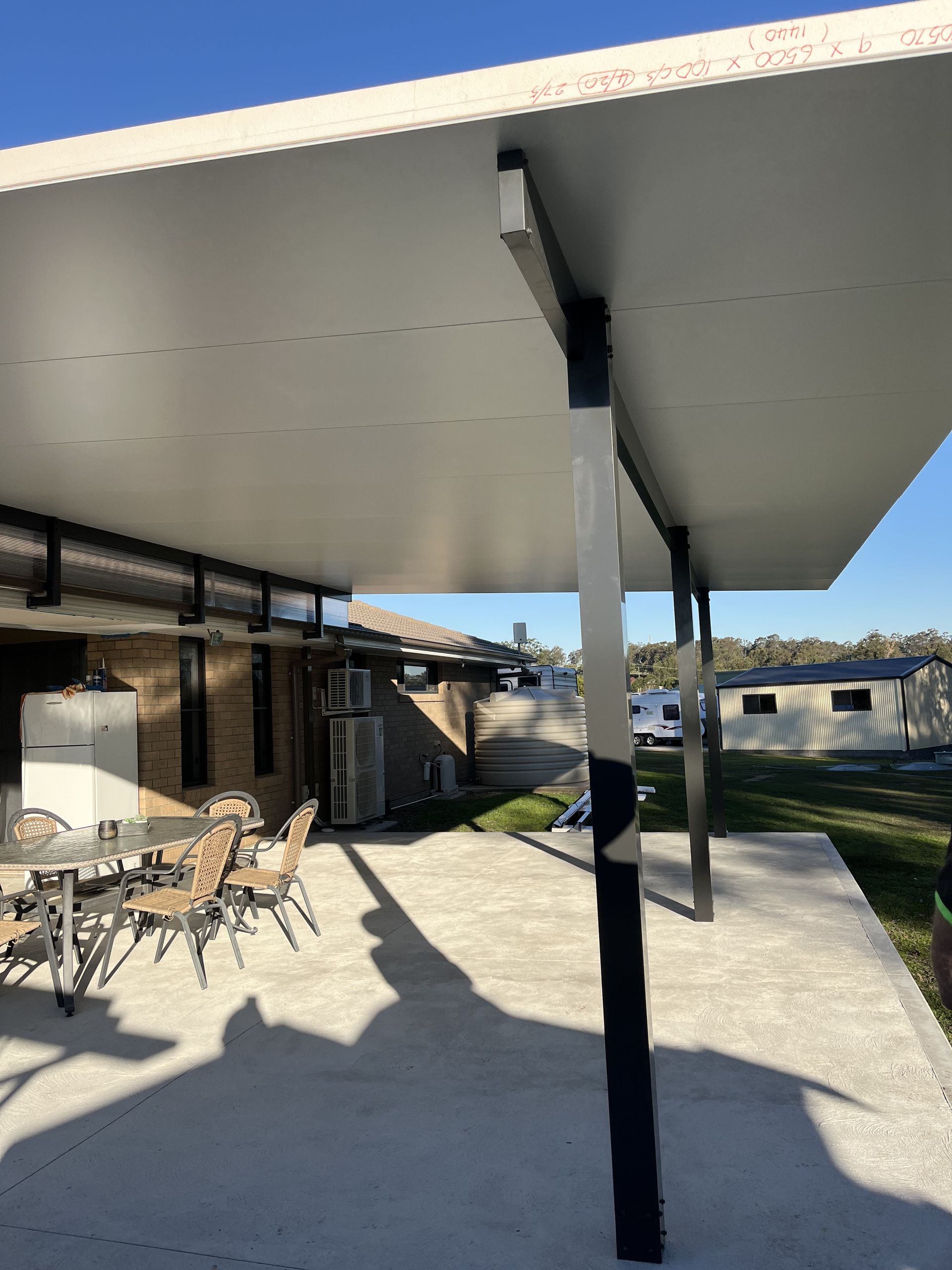 Patio With a Table and Chairs Under a Canopy — TM Built Construction In Thornton, NSW