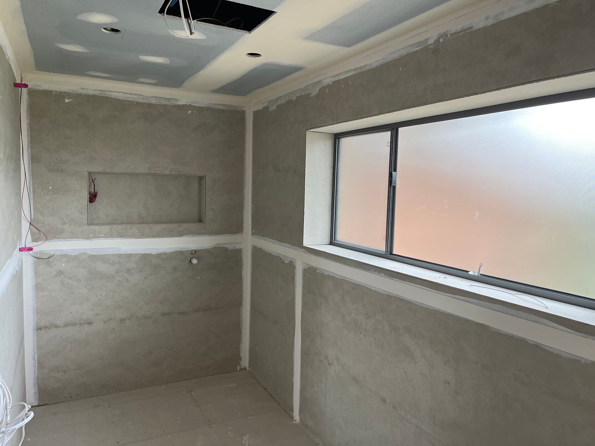 A room with a window and a hole in the ceiling — TM Built Construction In Lochinvar, NSW