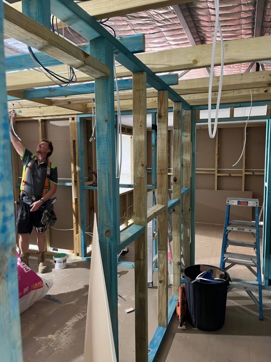 Man is Standing in a Room Under Construction — TM Built Construction In Maitland, NSW