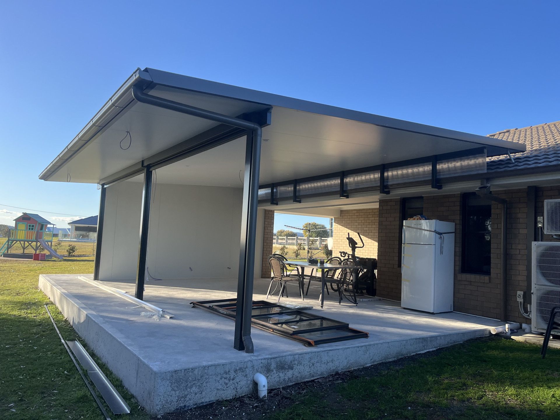 A Shed With a Deck and a Wooden Fence in a Backyard — TM Built Construction In Lochinvar, NSW