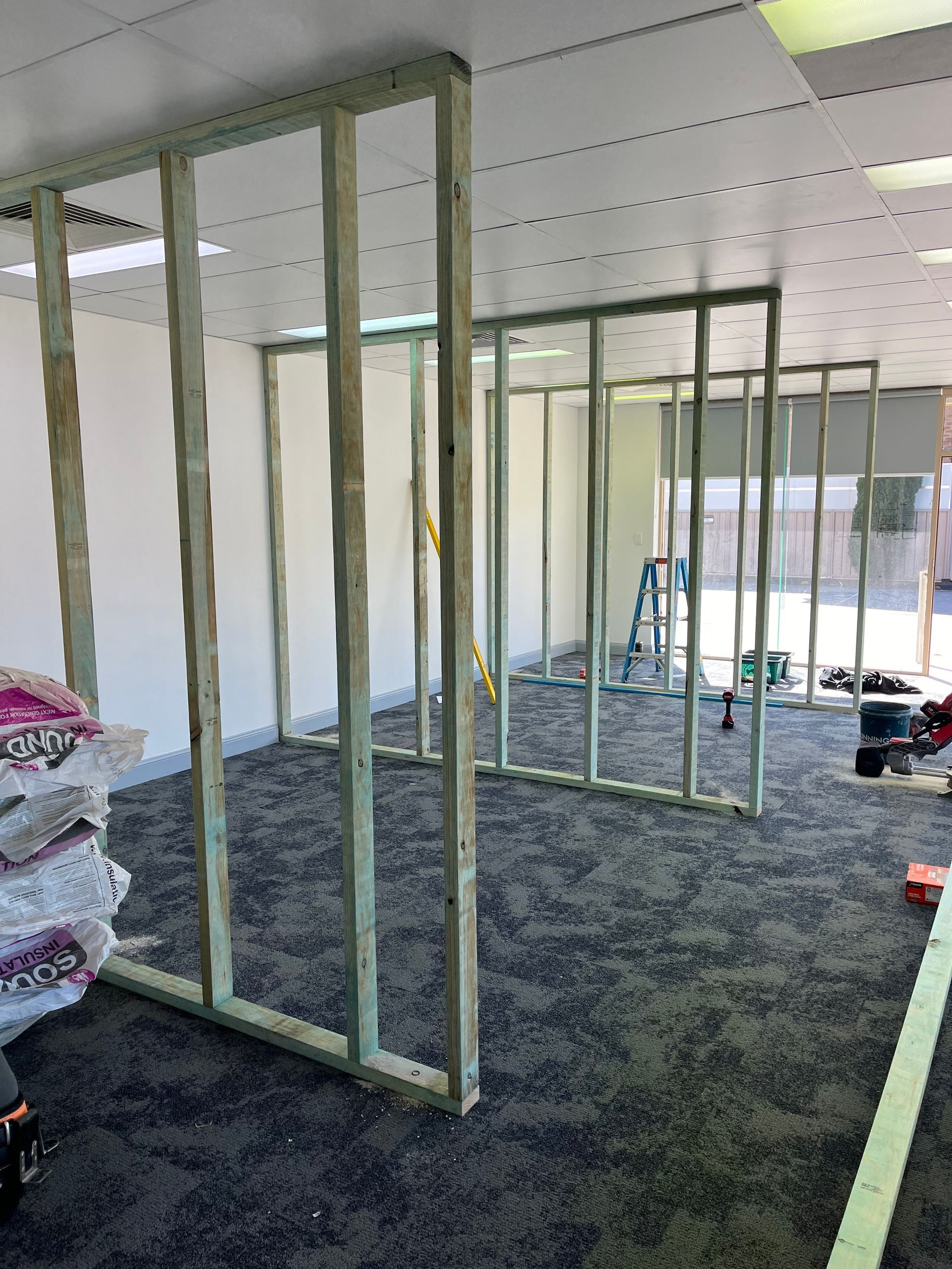A room with a lot of wooden walls and a carpeted floor — TM Built Construction In Lochinvar, NSW