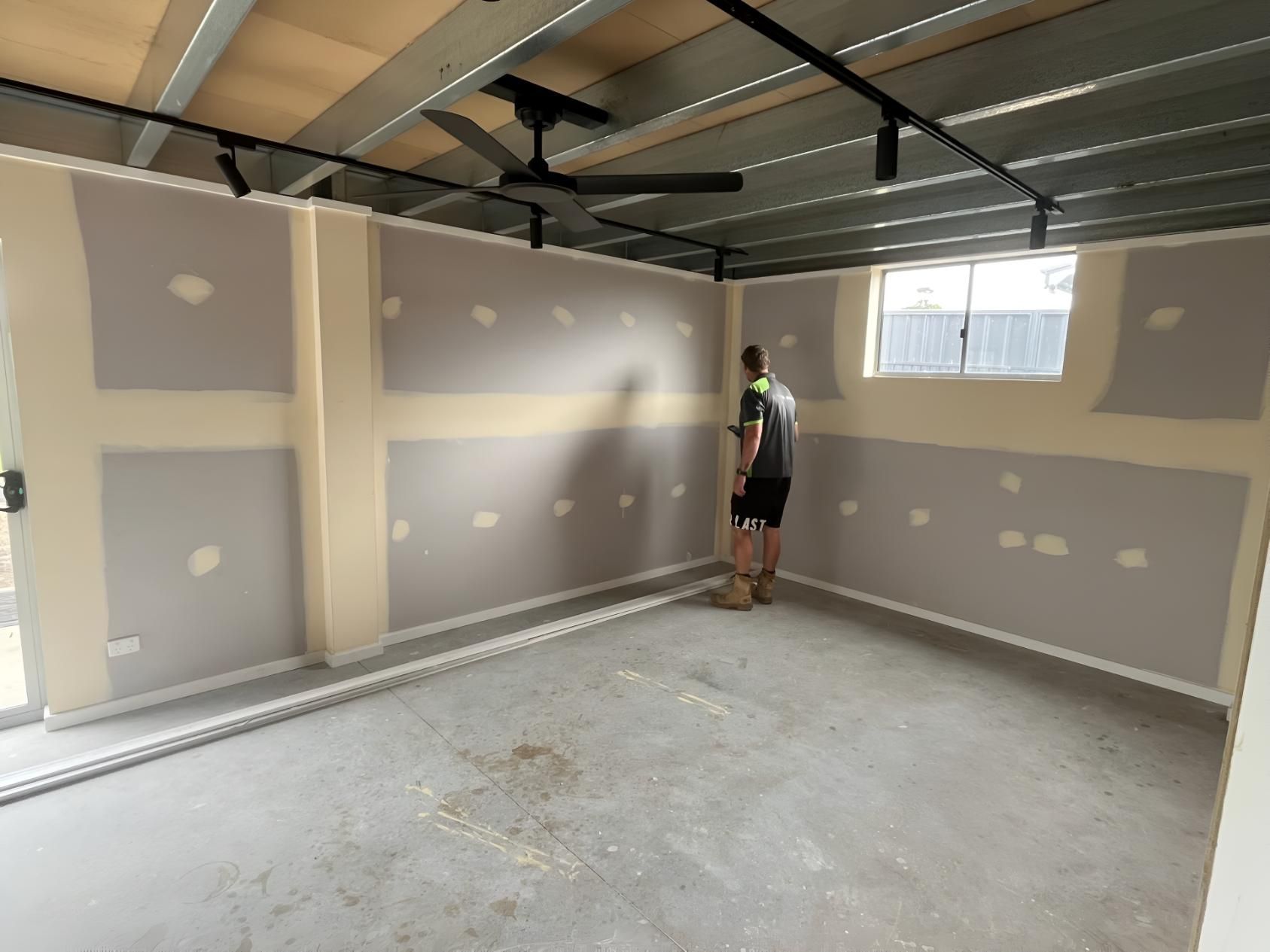 Man is Standing in an Empty Room — TM Built Construction In Branxton, NSW