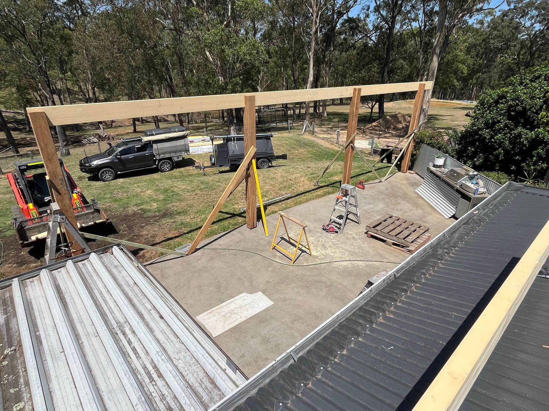 An aerial view of a roof with a wooden structure being built on it — TM Built Construction In Lochinvar, NSW