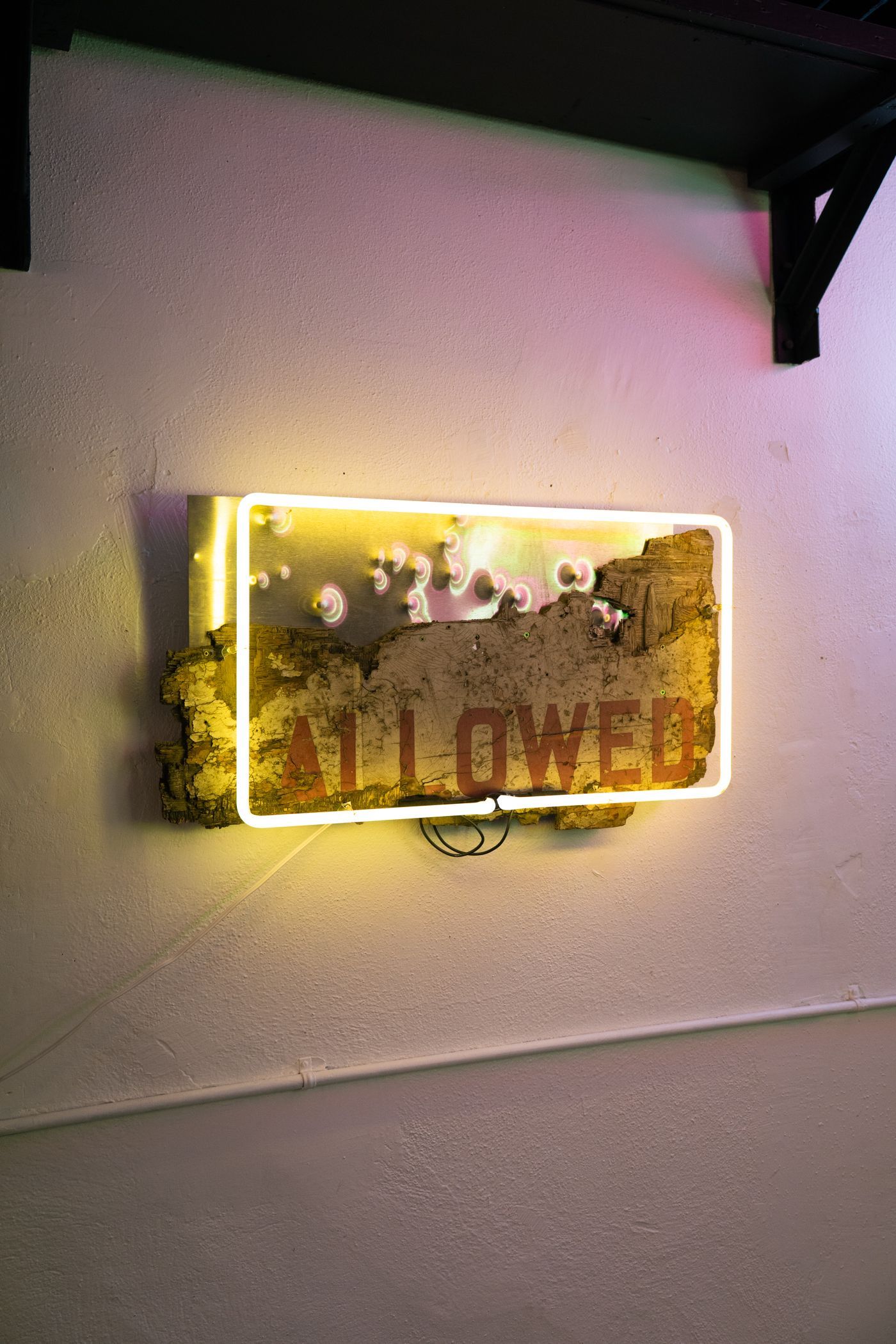 Yellow neon sign that spells 