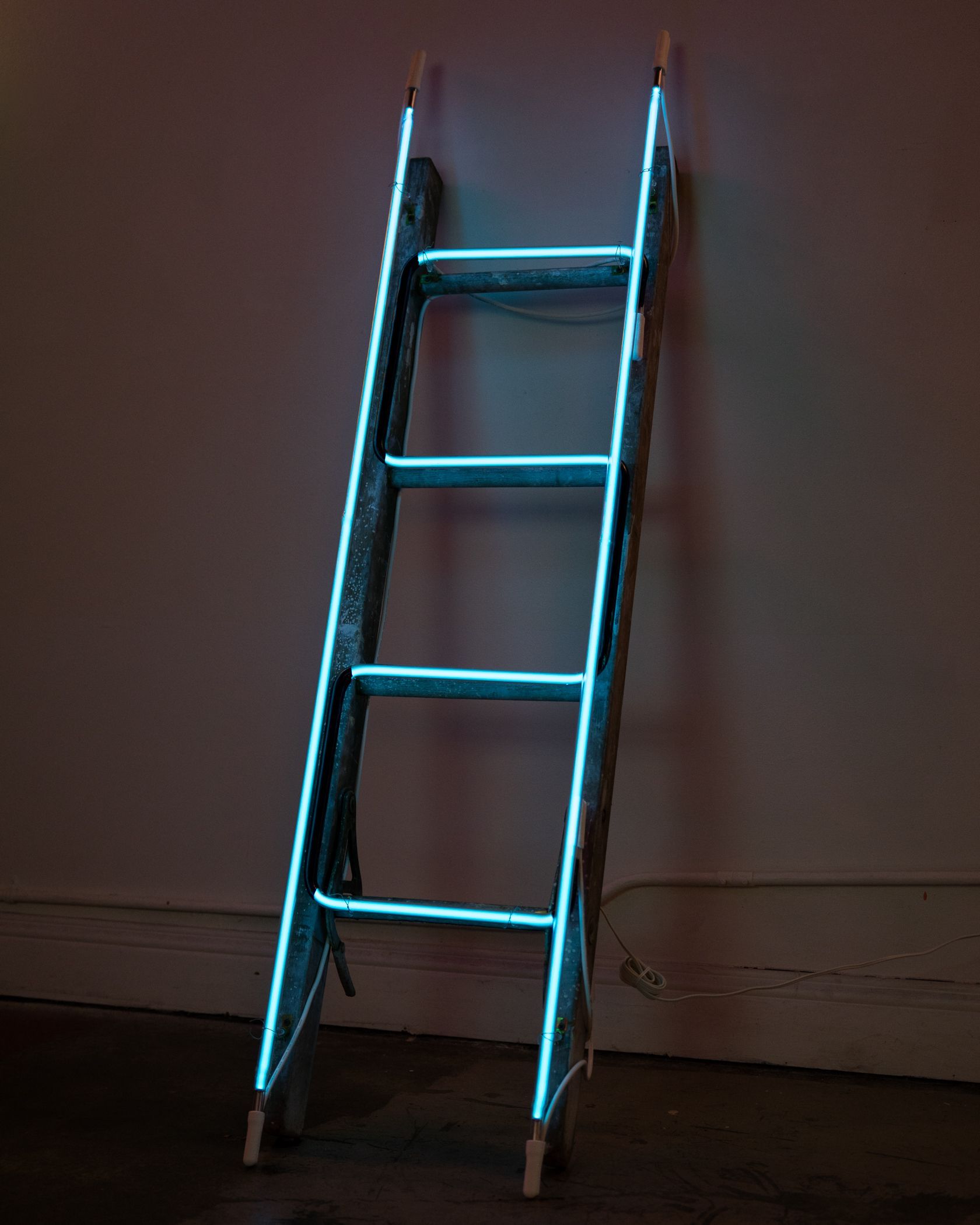 Blue neon outline of a ladder leaning against a wall in a dim room; art by Yale Wolf.