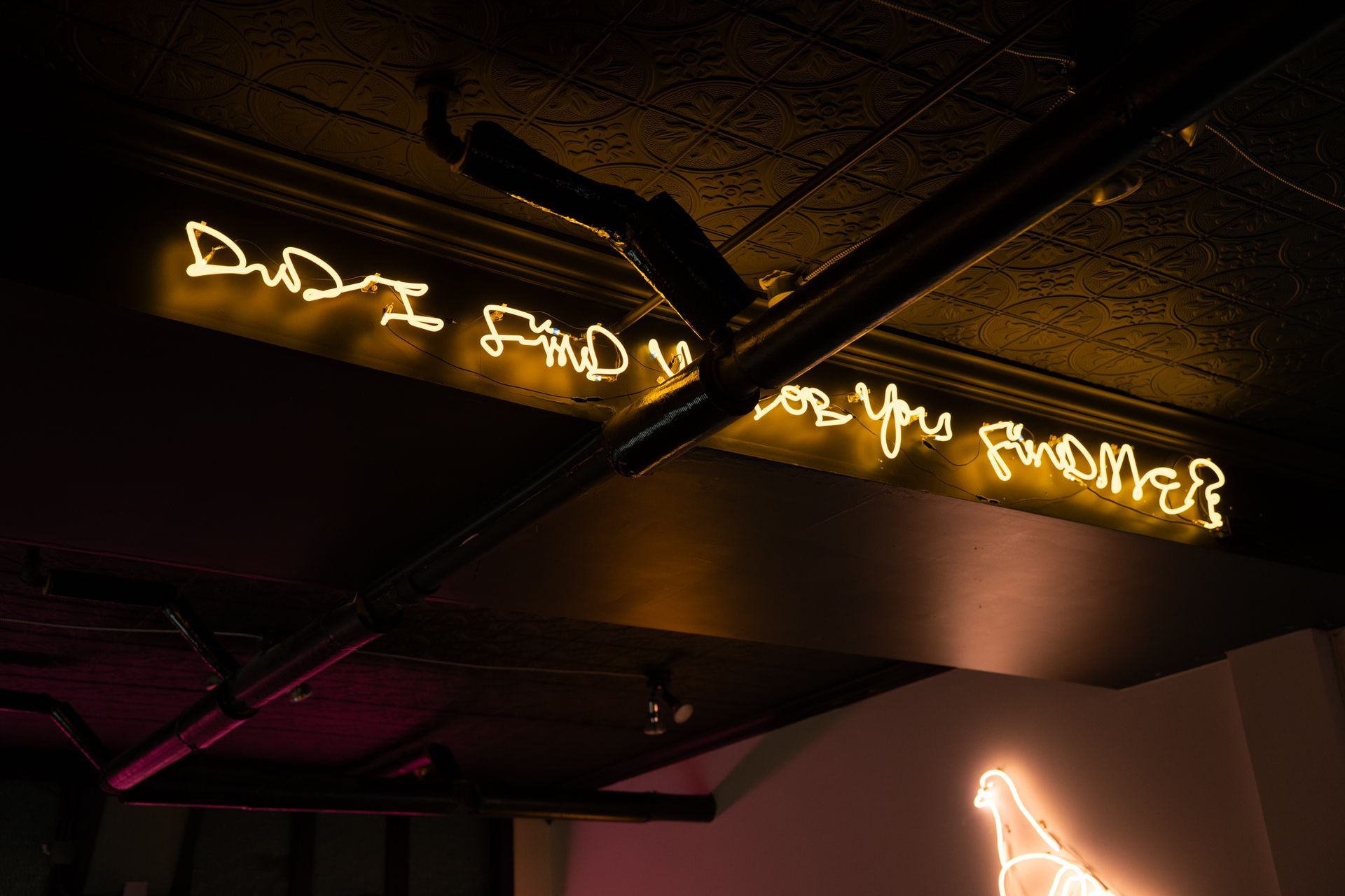 Yellow neon sign on ceiling: 