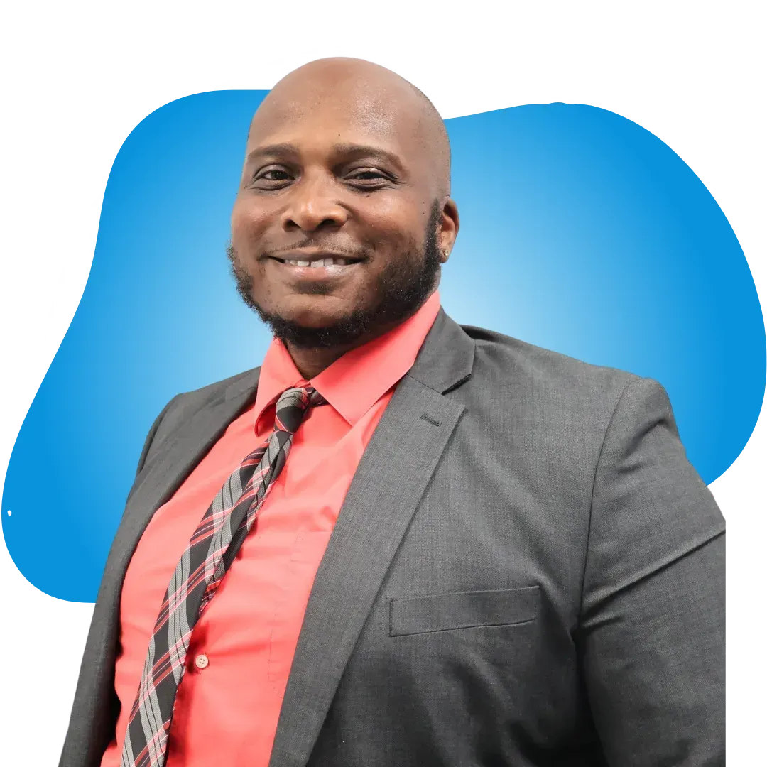 A man in a suit and tie is smiling for the camera