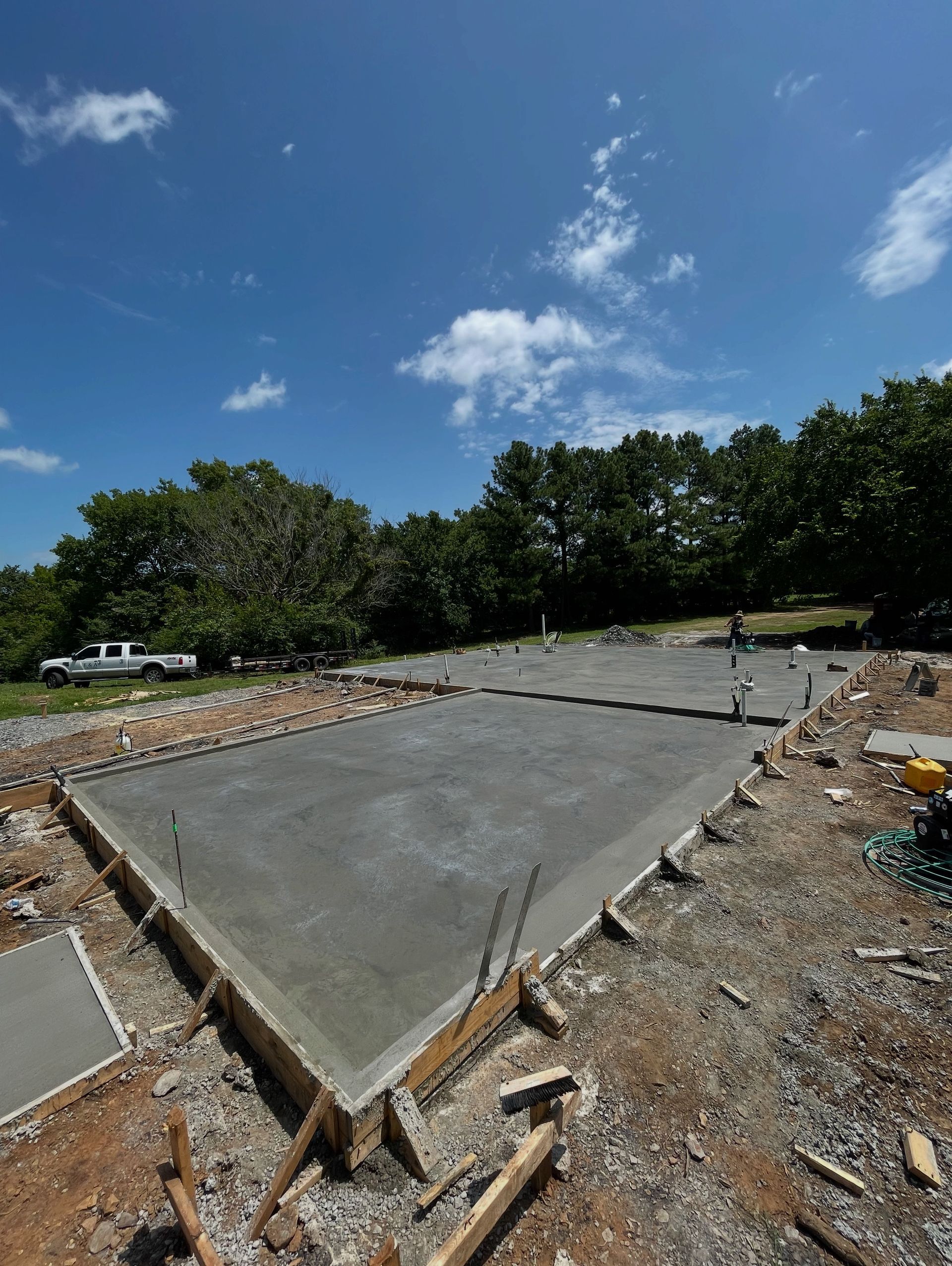 An aerial view of a concrete floor in the middle of a dirt field.