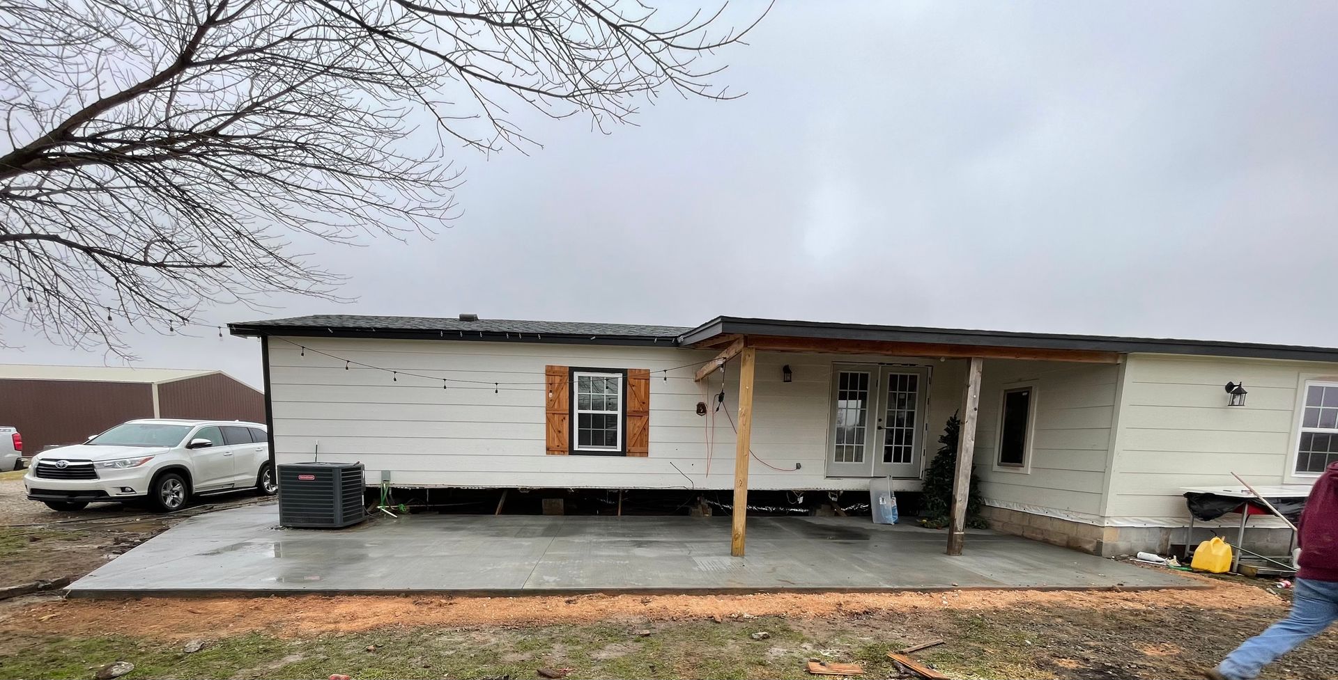 A mobile home with a concrete patio in front of it.