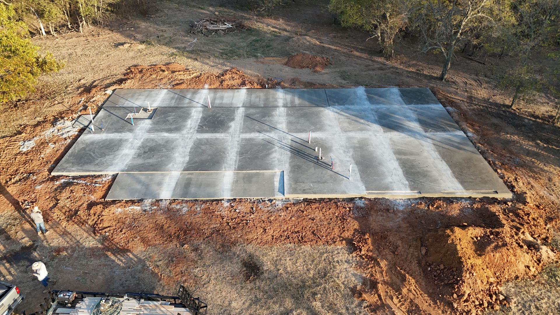 A concrete slab is sitting in the middle of a dirt field.