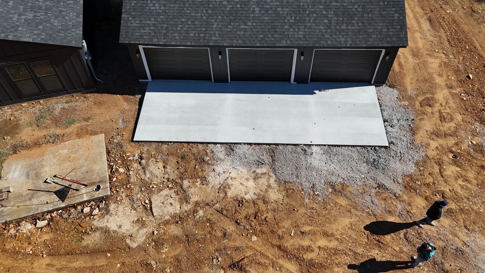 A concrete walkway is being built in front of a house.