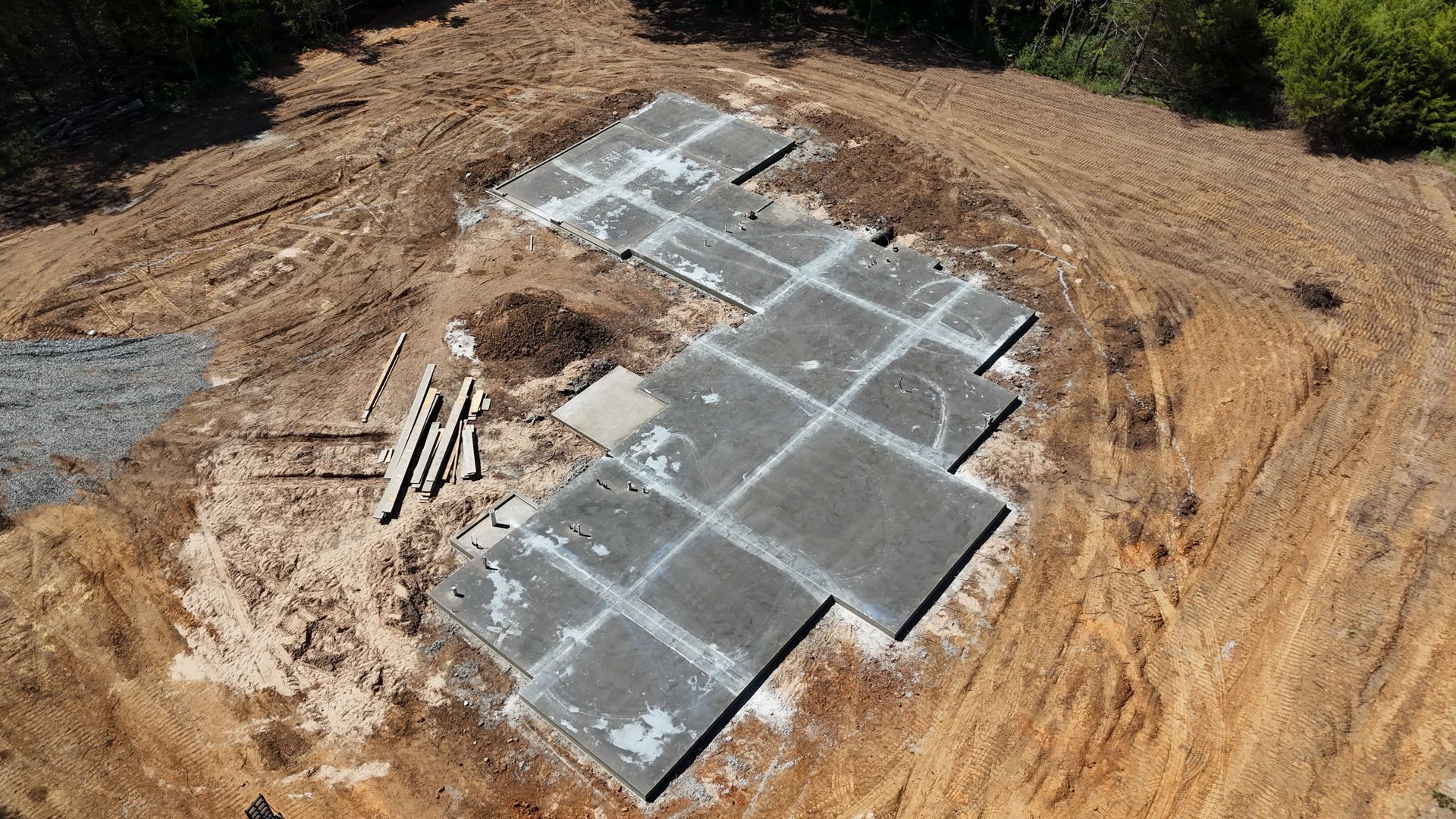 An aerial view of a house under construction in a field.