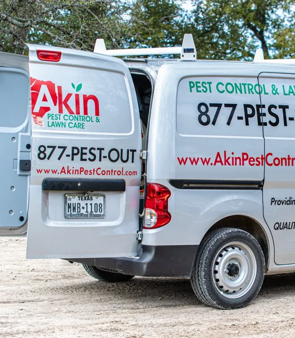 A white van that says akin pest control and lawn care