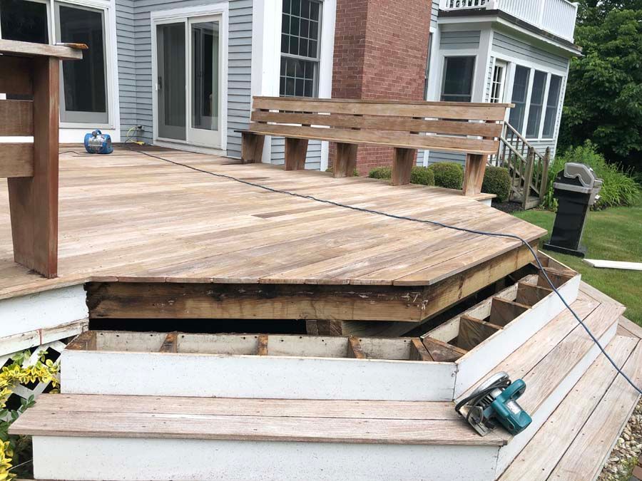 A wooden deck with stairs leading up to it.