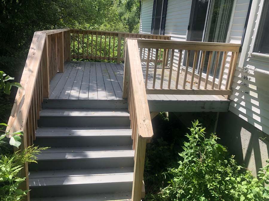 A wooden deck with stairs leading up to it.