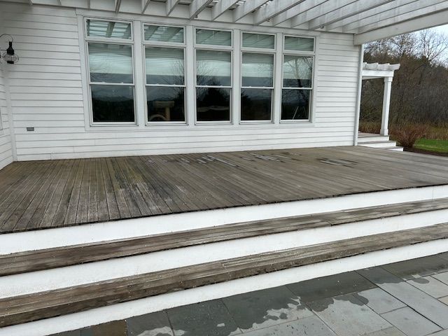 A wooden deck with stairs leading up to it.