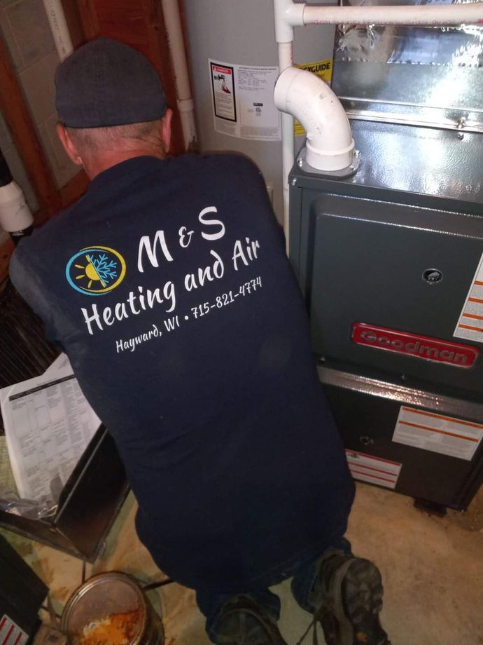 The Man Inspect the Water Heater-Hayward, WI-M & S Heating and Air LLC