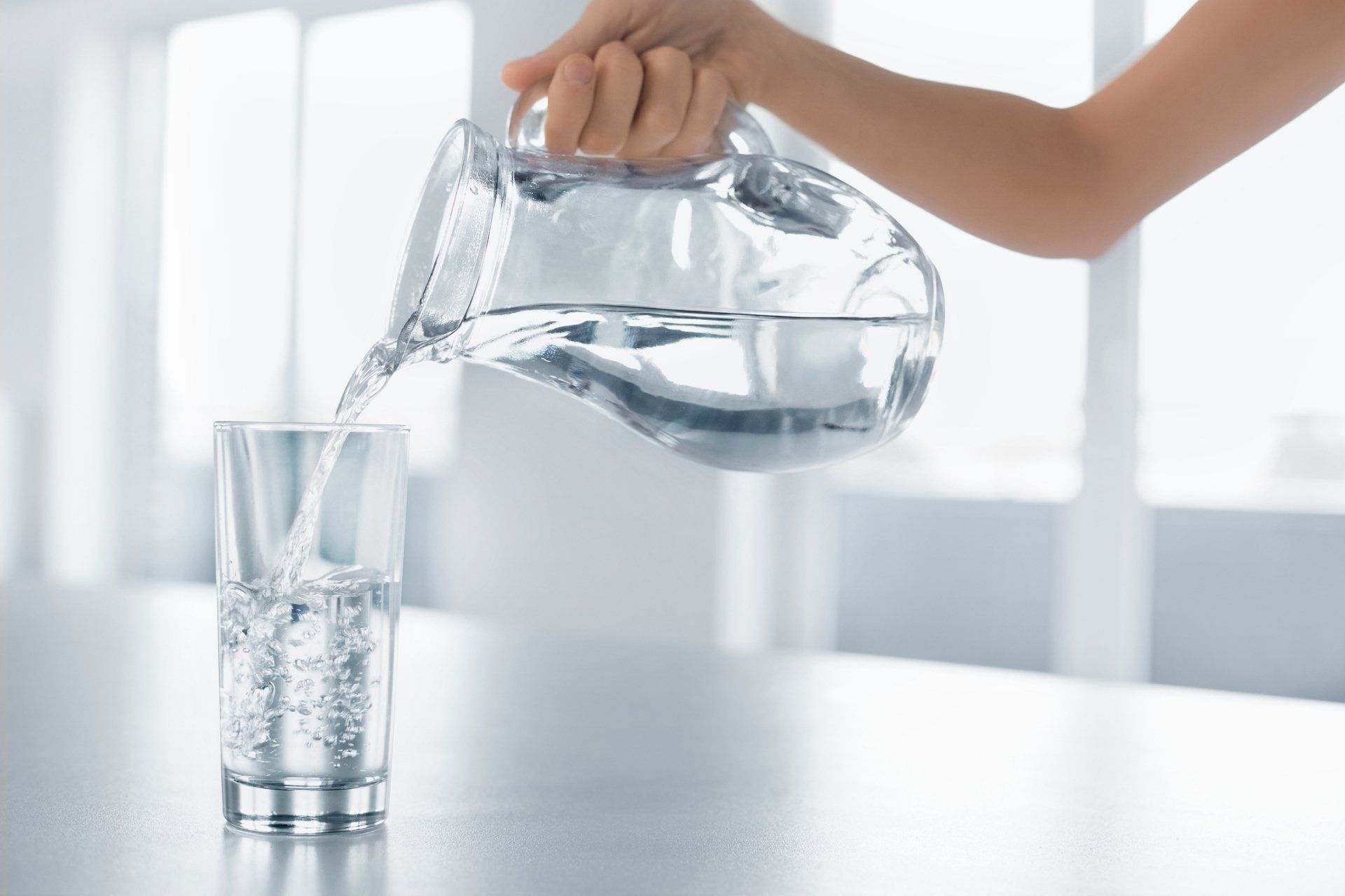 Pouring filtered water into a glass.