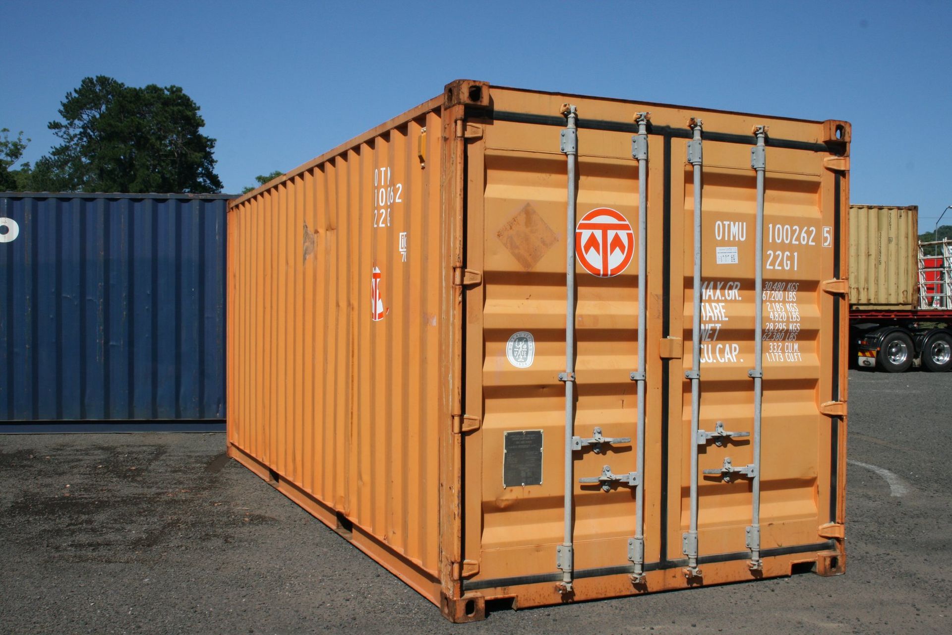 A shipping container with a garage door and a window.