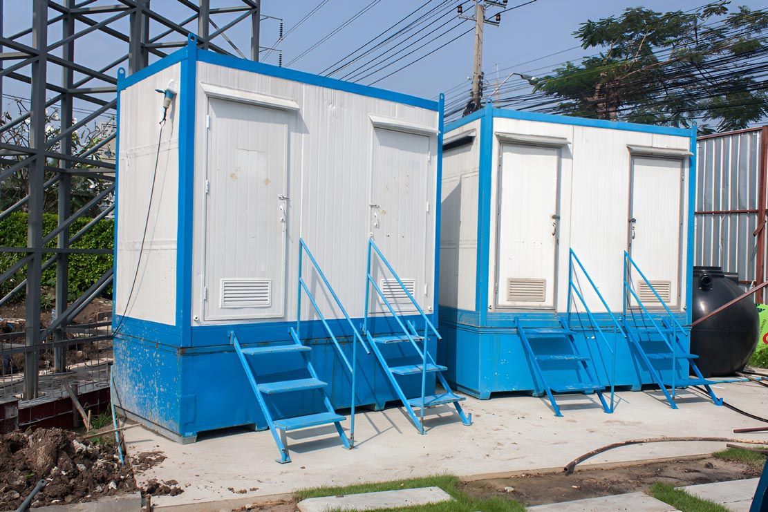 Row of Blue and White Portable Toilets with Stairs — East Coast Containers Shipping Containers and Transport in Brisbane, QLD