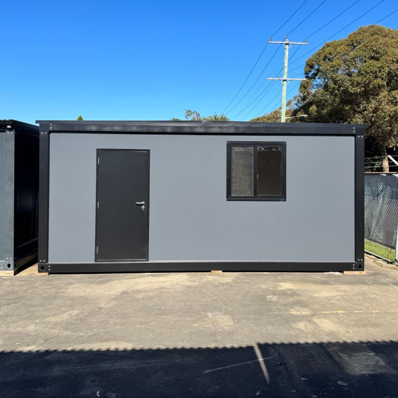 Gray rectangular office container with a black door — East Coast Containers Shipping Containers and Transport in Brisbane, QLD