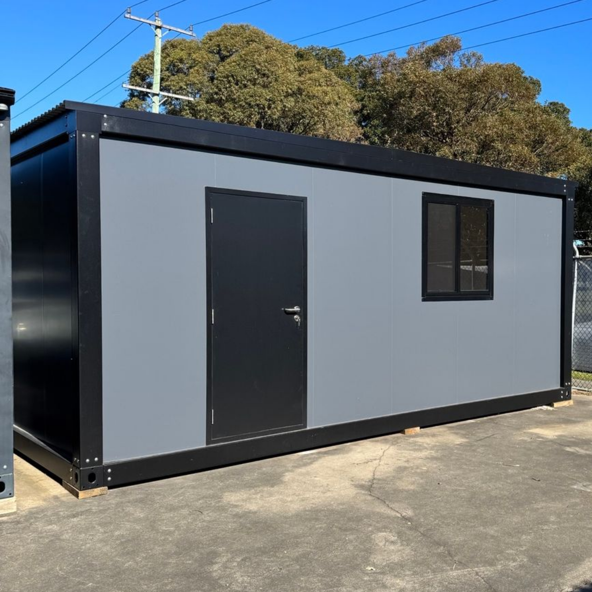 Gray rectangular office container with a black door — East Coast Containers Shipping Containers and Transport in Brisbane, QLD