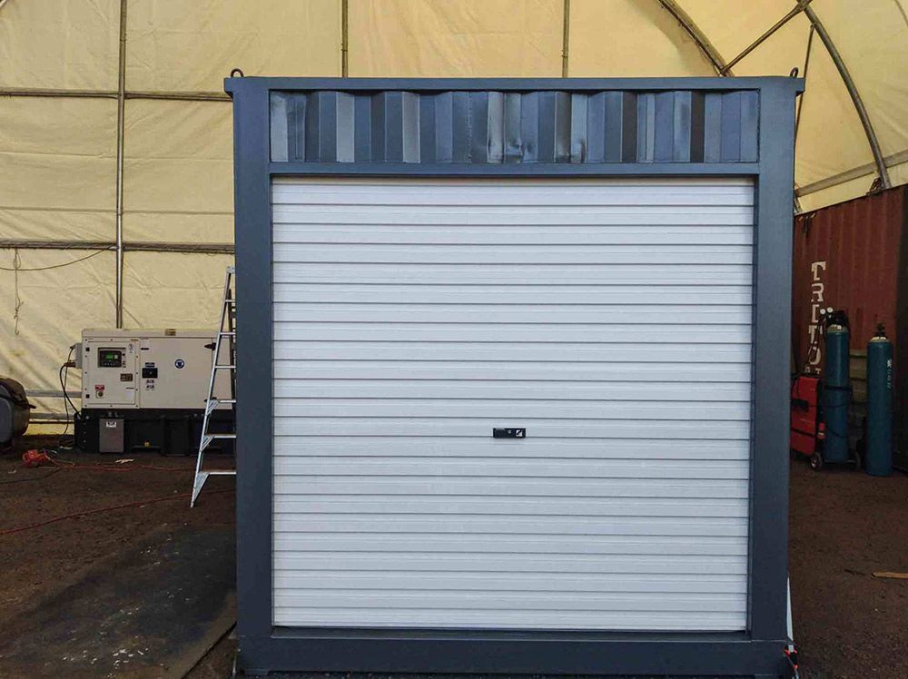 Gray Container with a White Roller Shutter Door — East Coast Containers Shipping Containers and Transport in Gold Coast, QLD