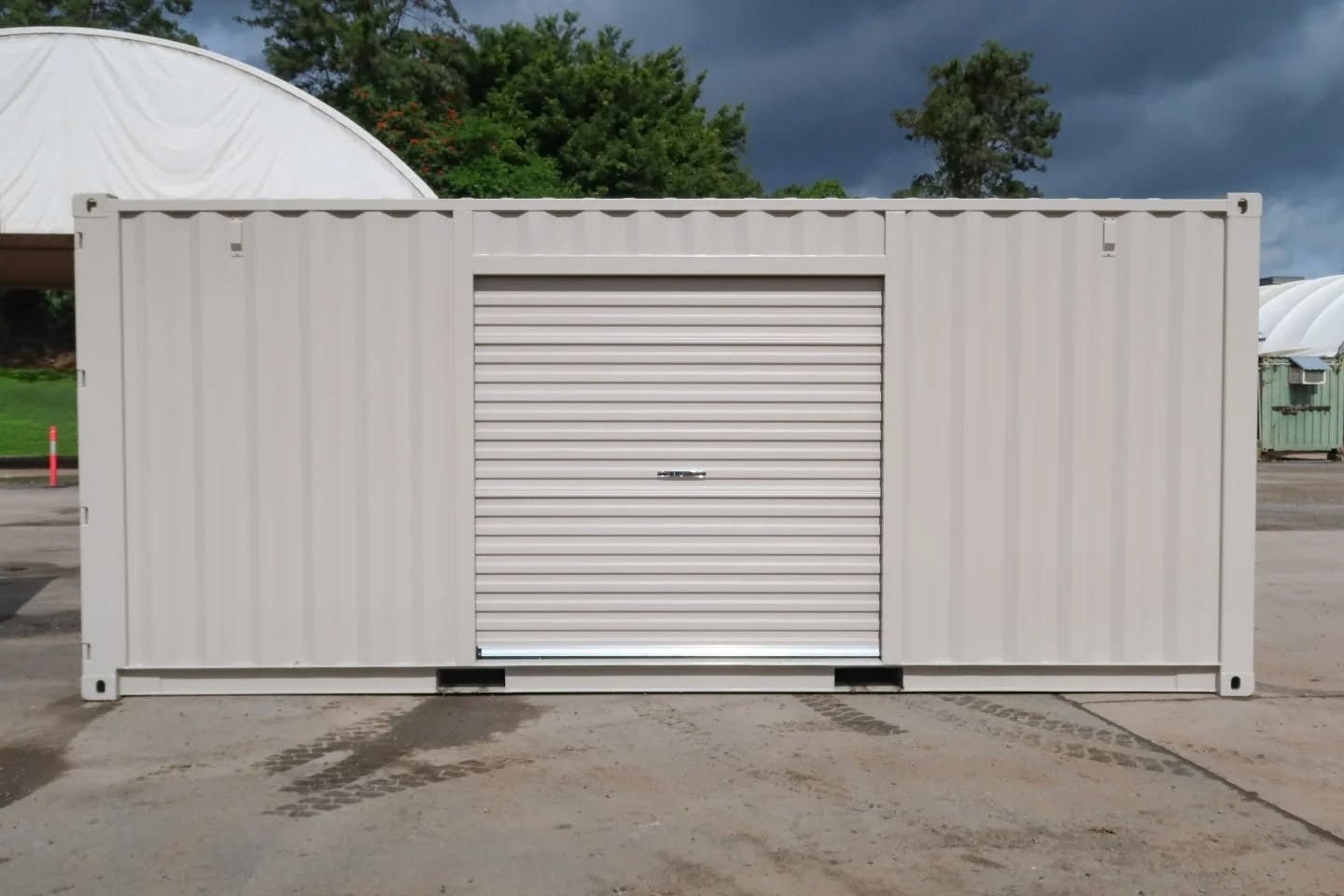 Tan Shipping Container With a Closed Roll-up Door