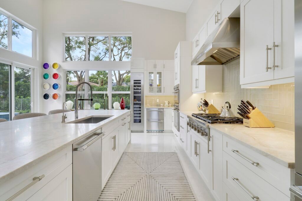 A kitchen with white cabinets and stainless steel appliances.