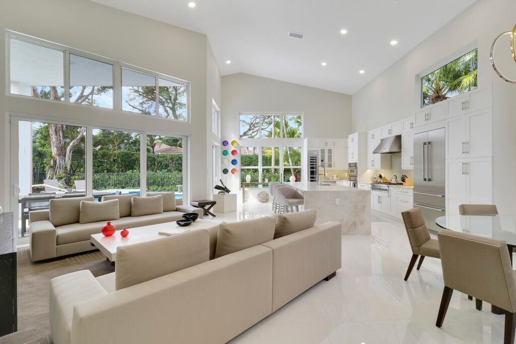 A living room with a couch , chairs , and a table.