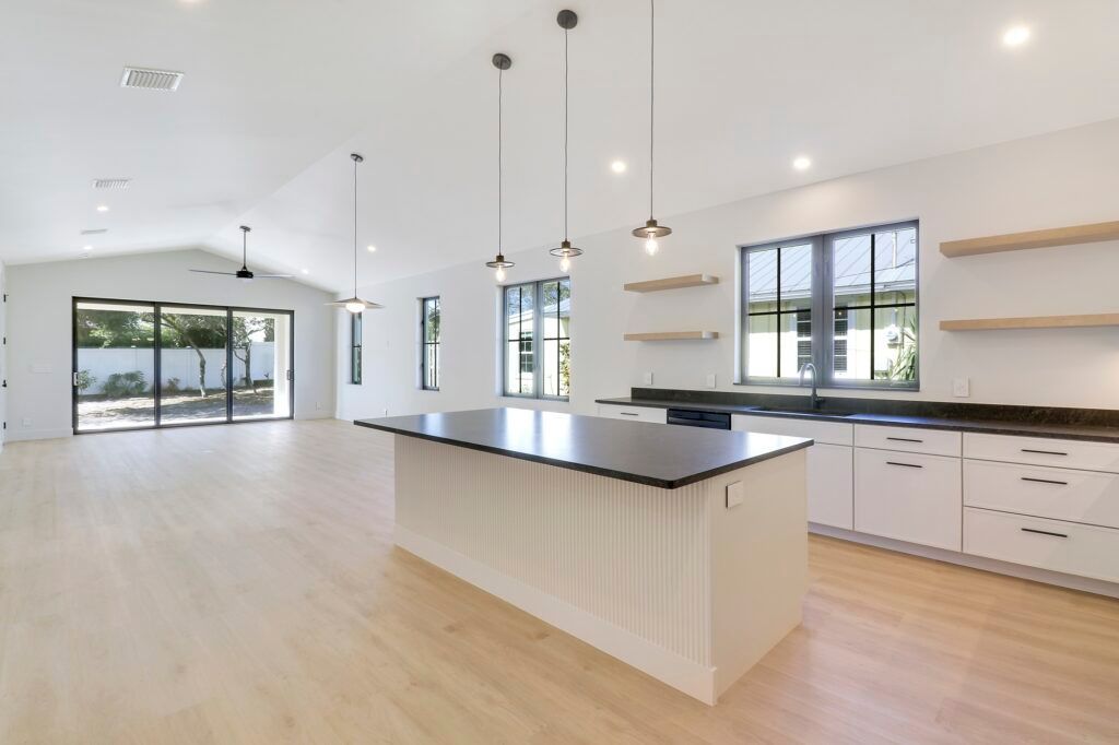 An empty kitchen with a large island in the middle