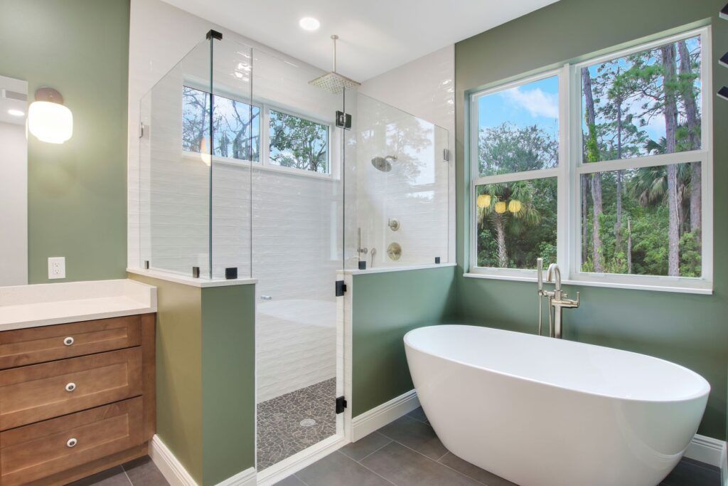A bathroom with a bathtub and a walk in shower.