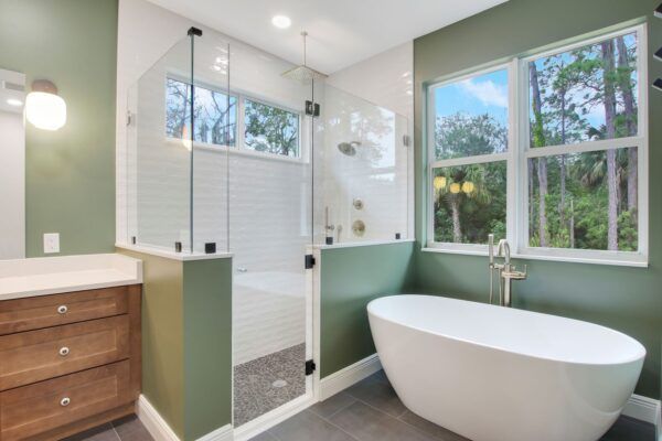 A bathroom with a bathtub , shower , and window.