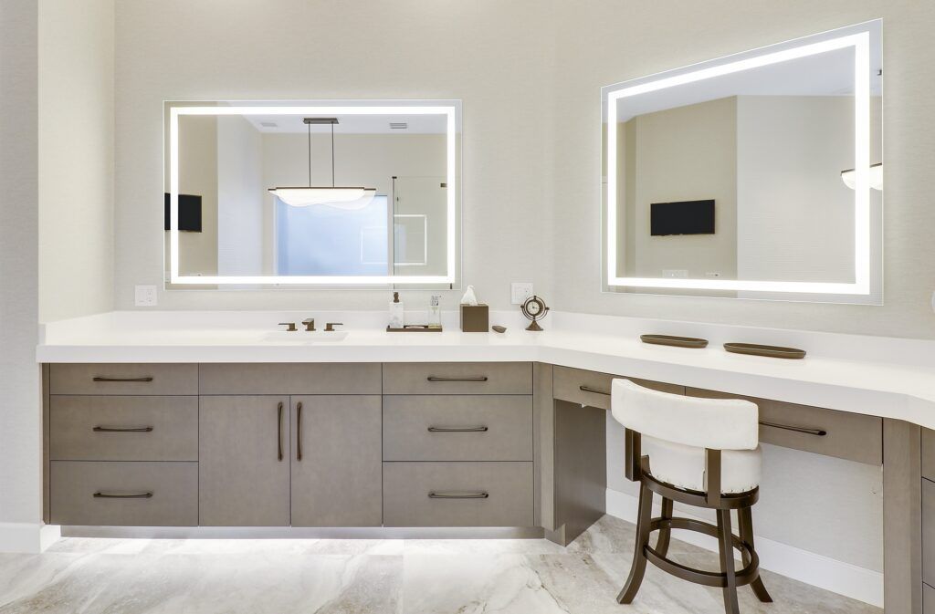 A bathroom with two mirrors and a vanity.