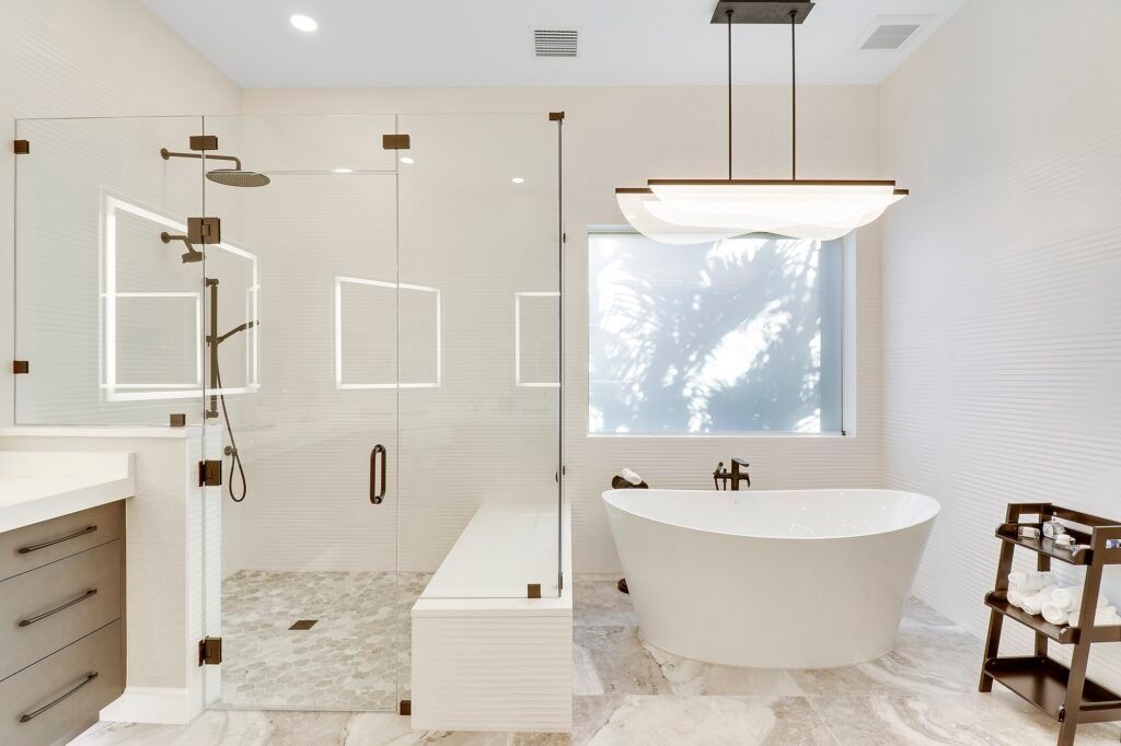 A bathroom with a bathtub and a walk in shower