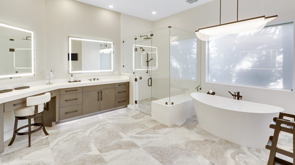 A bathroom with a tub , sinks , mirrors and a large window.