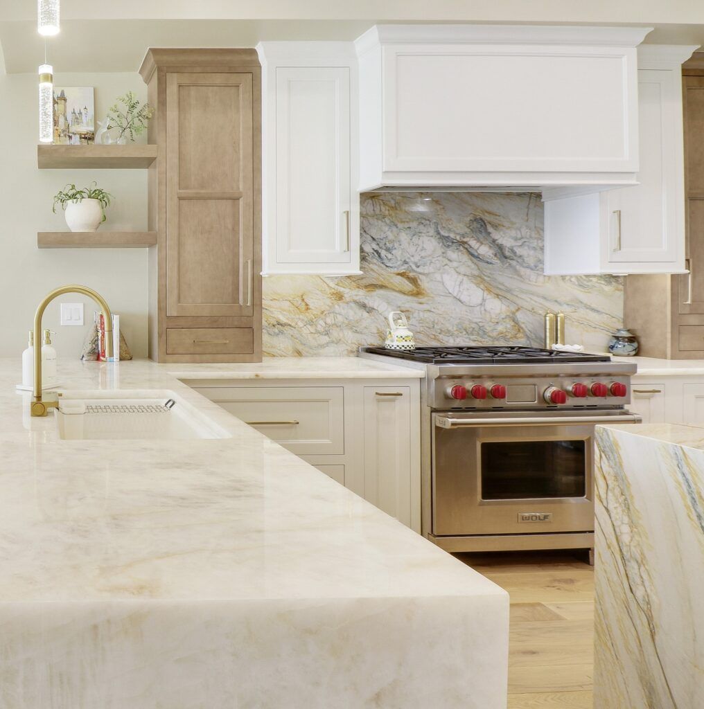 A kitchen with stainless steel appliances and white cabinets