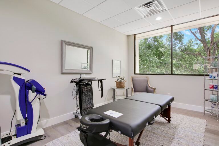 There is a massage table in the middle of the room.