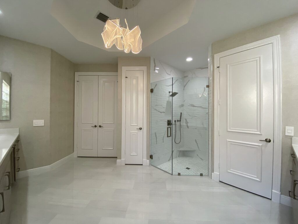 A bathroom with a walk in shower and two sinks.
