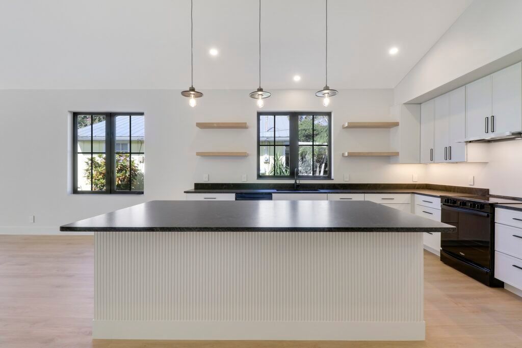 An empty kitchen with a large island in the middle
