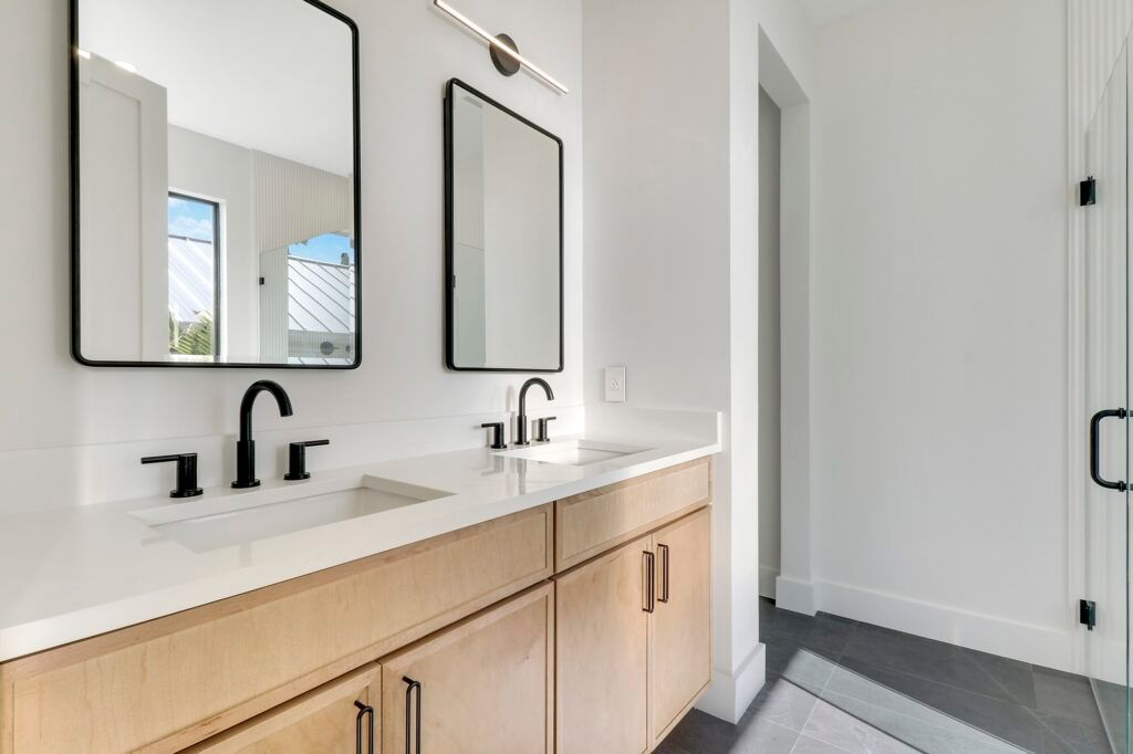 A bathroom with two sinks and two mirrors.