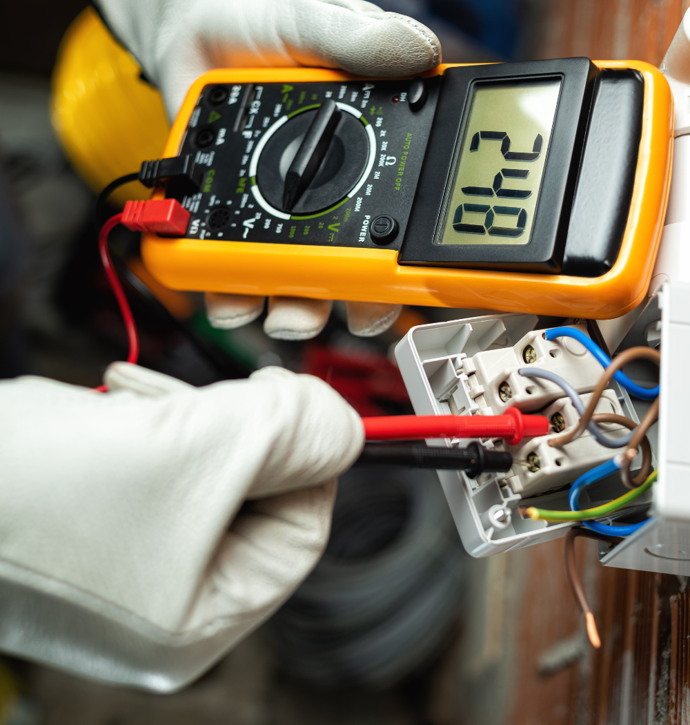 A close up of an air conditioner being repaired with gauges attached to it.