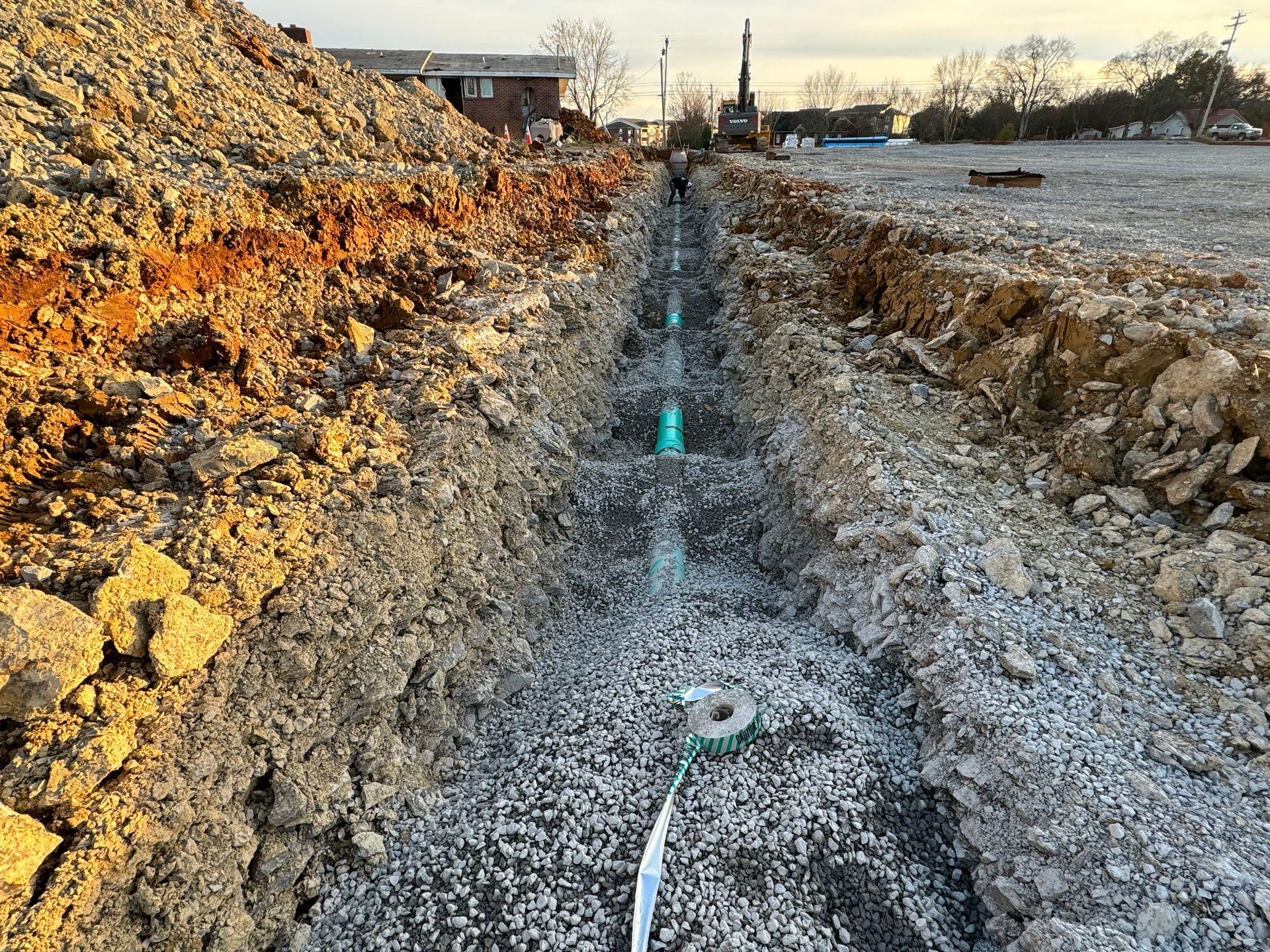A pipe is being installed in a hole in the ground.
