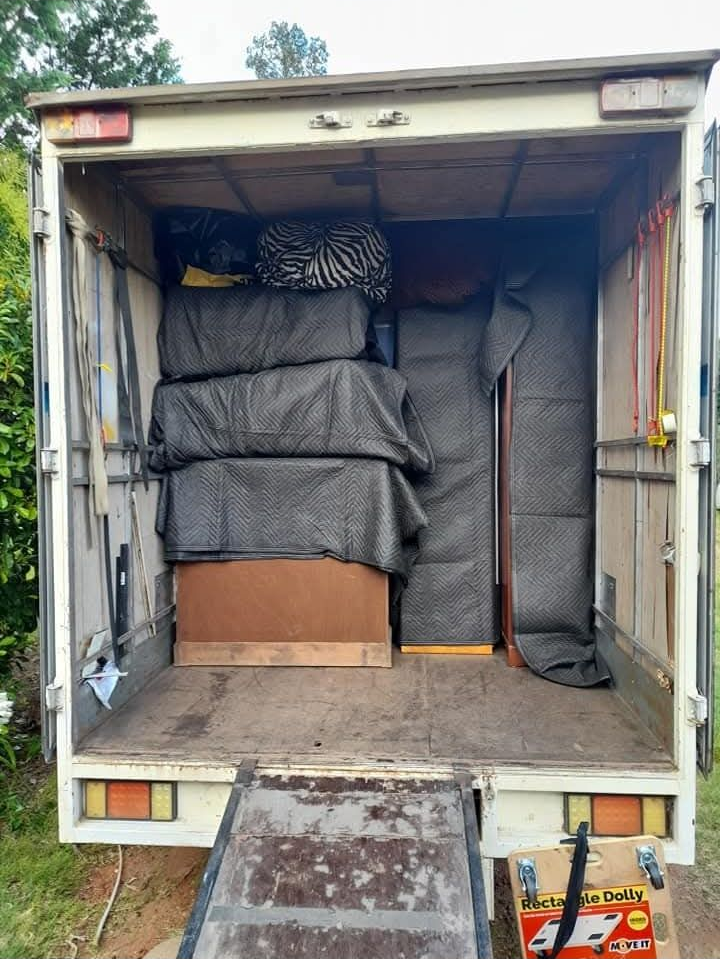 Open moving truck filled with wrapped furniture and boxes, rear ramp down — TJ Removals and Storage in Wagga Wagga, NSW