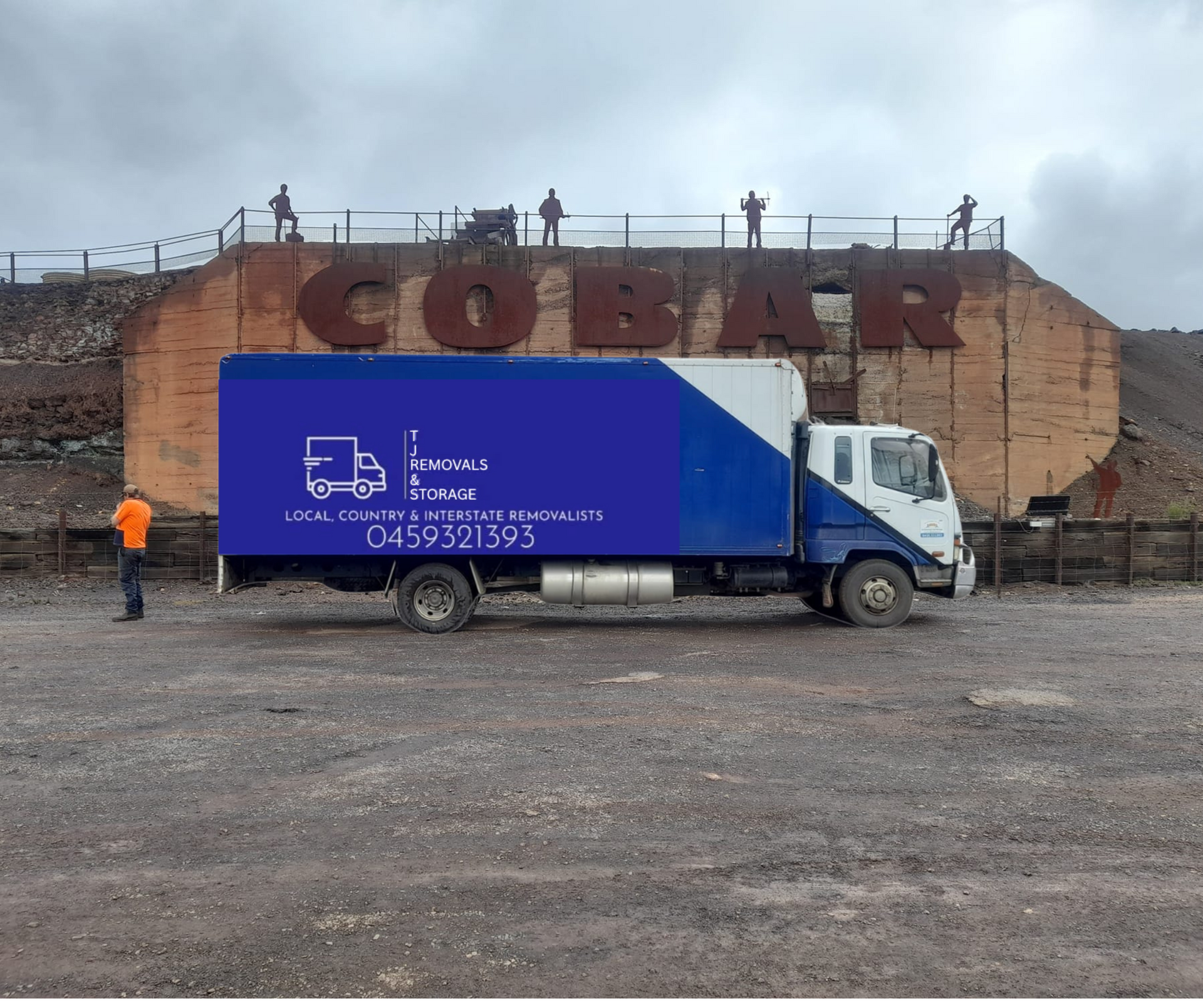 A Family is Standing in Front of a Moving Truck — TJ Removals and Storage in Junee, NSW