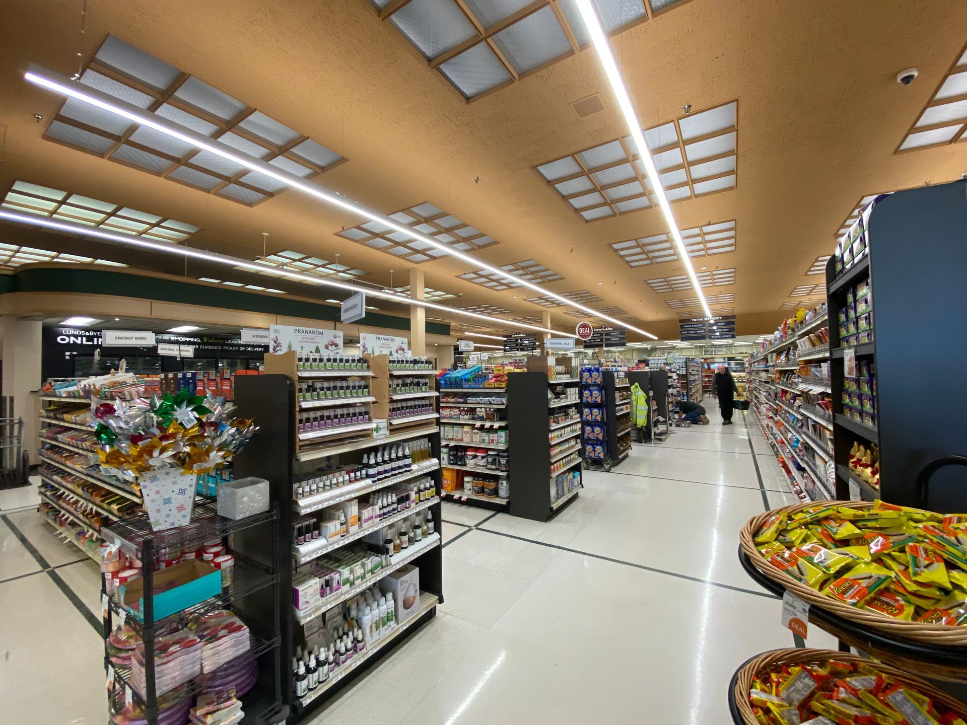 A large grocery store filled with lots of shelves and aisles.