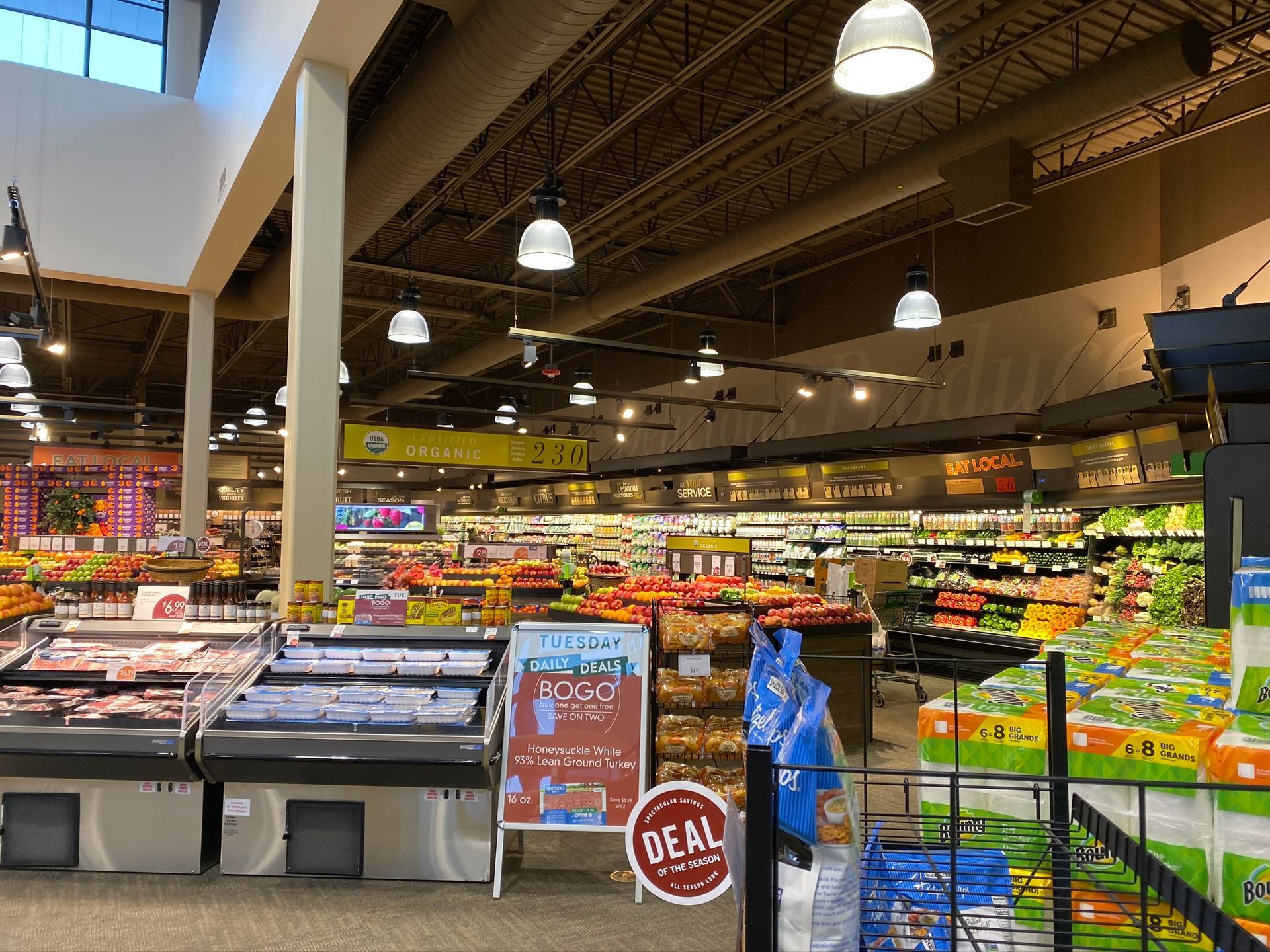 The inside of a grocery store with a sign that says `` deal ''.